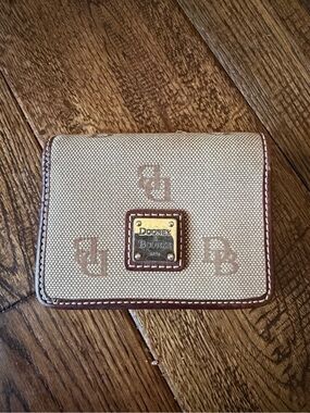 Dooney & Bourke Beige Canvas Wallet with Brown Trim and Logo Plaque